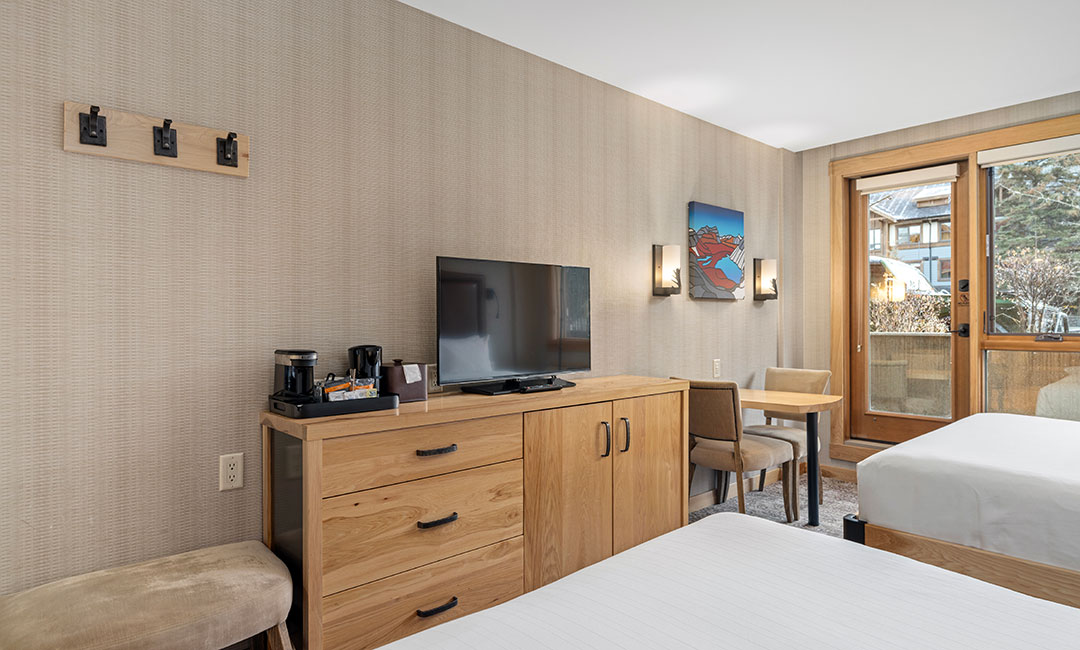 Accessible hotel room with TV and dresser